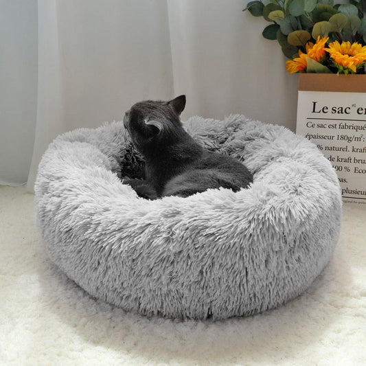 Brown fluffy dog bed in donut shape with long plush material, orthopedic lounger for dogs and cats, 40cm diameter.