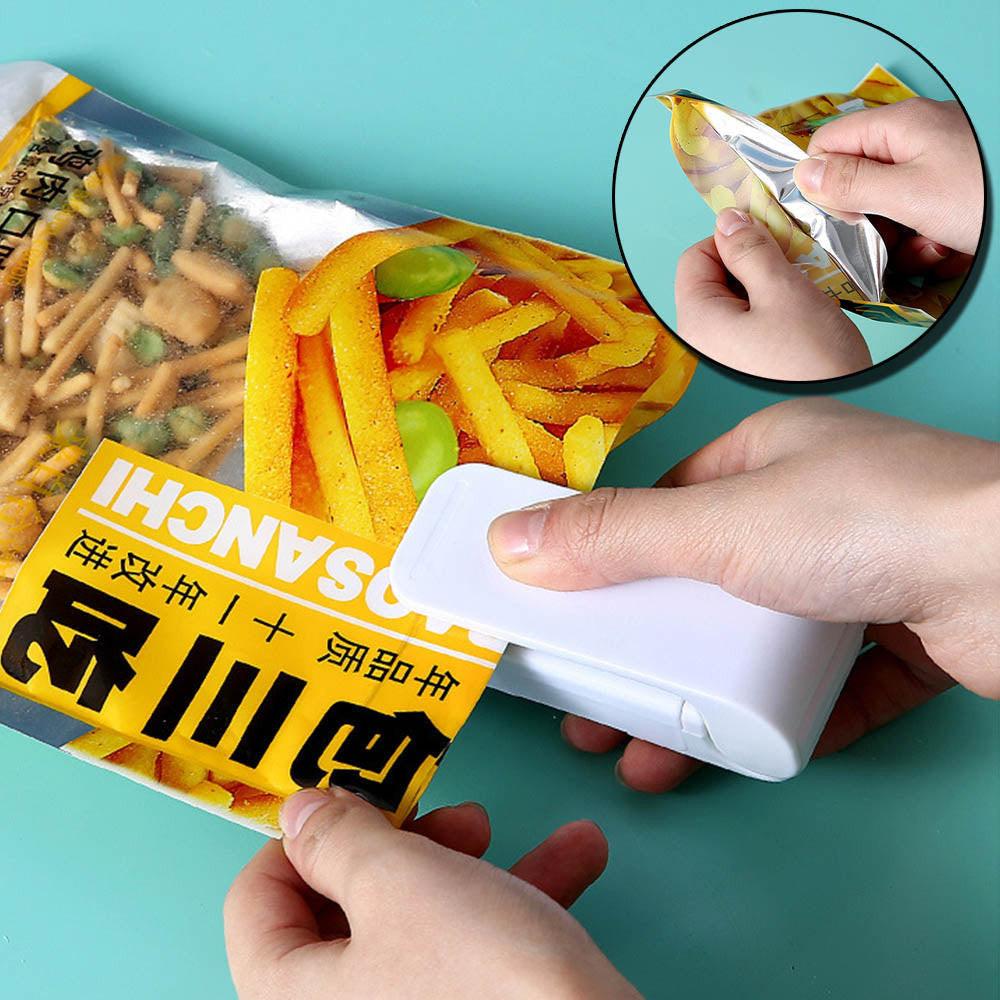 Dev2-aff mini heat bag sealing machine with white portable sealer for thermal plastic food bags and kitchen packaging.