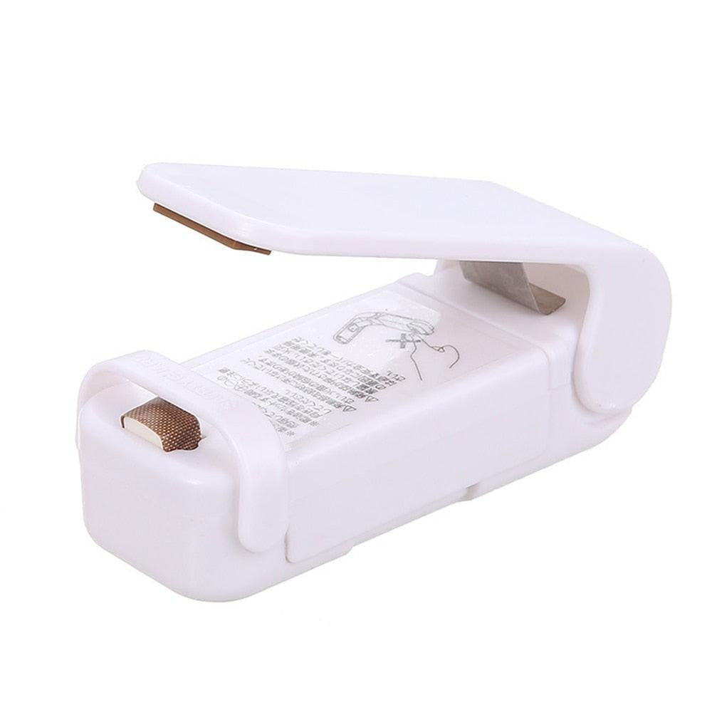 Dev2-aff mini heat bag sealing machine with sealer bags, portable plastic food bag closure for kitchen packaging.